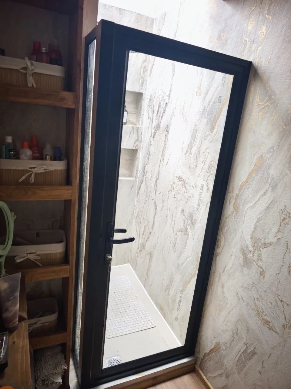 Shower door de cristal templado con herrajes negros instalado por DM Cristales